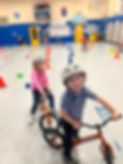 Kids on balance bikes at Simonds School.jpg