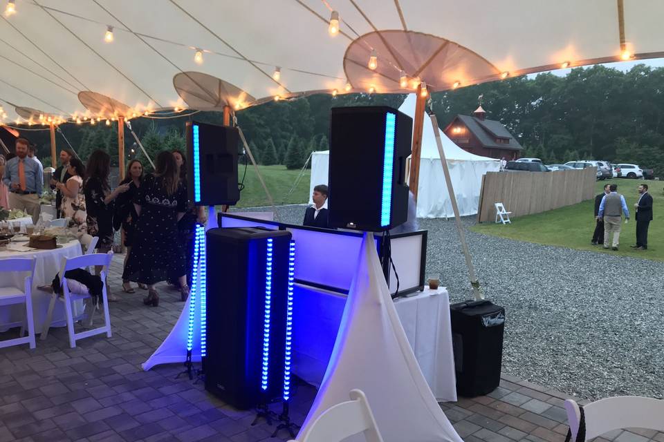 Professional DJ booth setup at an outdoor tent wedding reception — AMP Events & Lighting provides full DJ and lighting services for Houston outdoor weddings