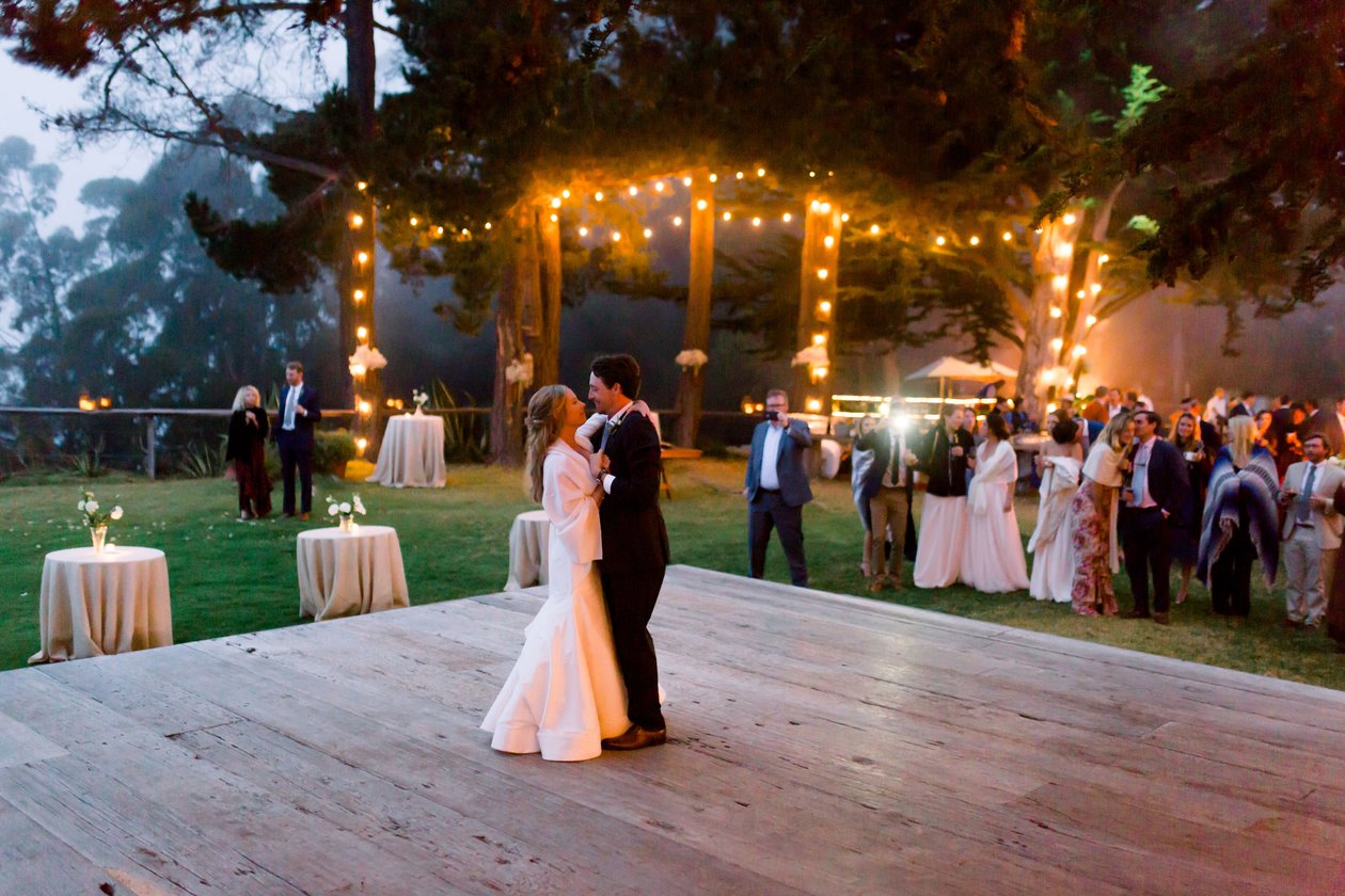 Couple sharing first dance on outdoor wooden dance floor under string lights — AMP Events & Lighting creates unforgettable outdoor wedding receptions in Houston