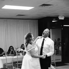Black and white photo of a bride and groom dancing.