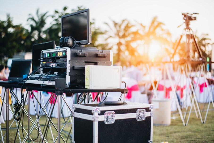 Outdoor event DJ and speaker setup with professional audio equipment — AMP Events & Lighting designs zone-based sound systems for Houston outdoor receptions