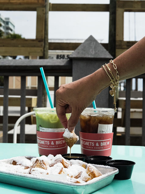 Delicious beignets and coffee along with matcha posed harbor side along Florida.