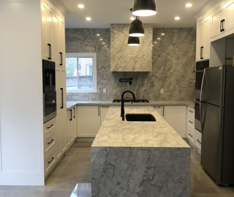 Gray marble quartz countertop and backsplash with black faucet installed by GTA Kitchen Depot Toronto.