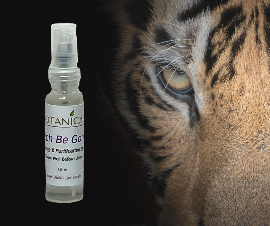 Tiger in background of travel sized bottle of Bitch Be Gone purification spray