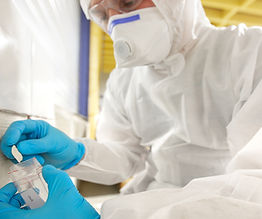 Asbestos Assessor taking a sample of asbestos from Building substrate