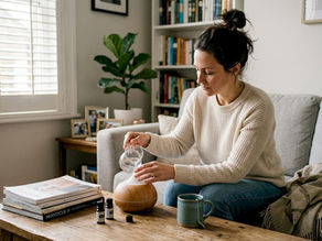 Woman preparing essential oil diffuser at home