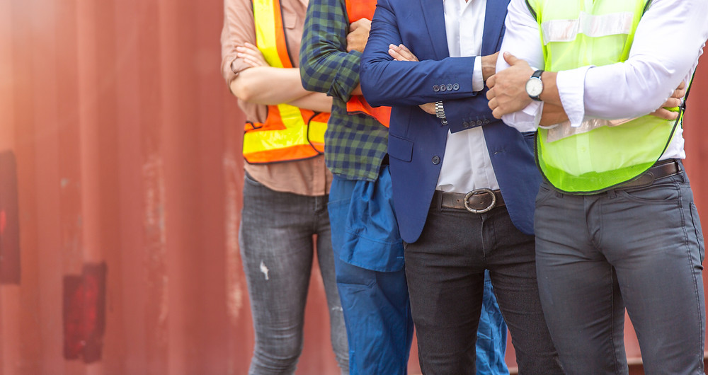 Four different workers from multiple industries standing in a line