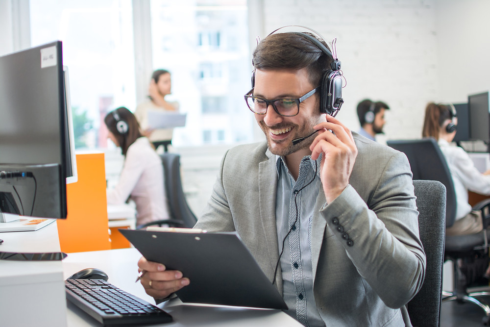 Man using a campaign guide to speak with people over the phone