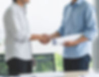 Firefly two people dressed in casual business attire, shaking hands. One of them is holdin