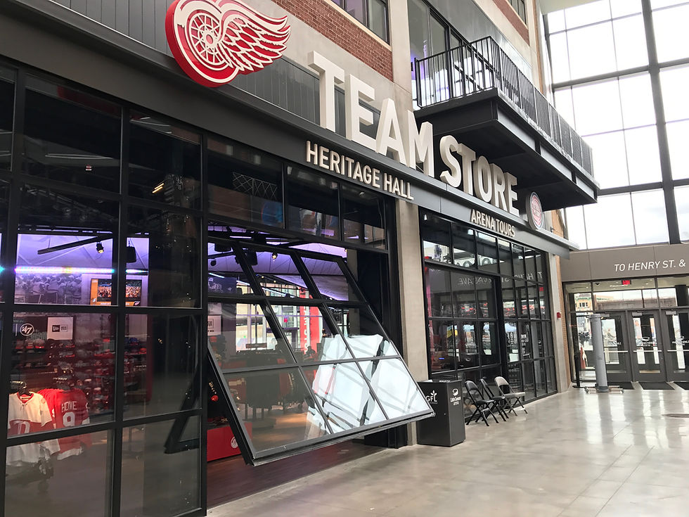 Sports venue team store featuring a large operable glass wall that opens the retail space to the stadium concourse