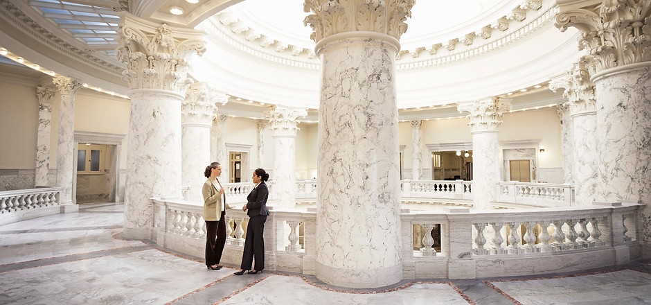Two Women Speaking in a professional atmosphere.