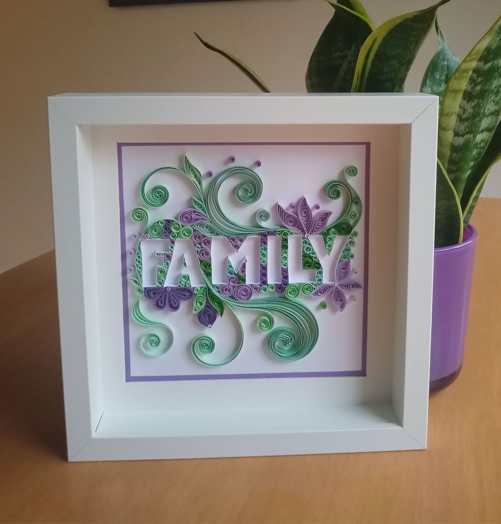 Quilling wall art with 'FAMILY' in purple and green