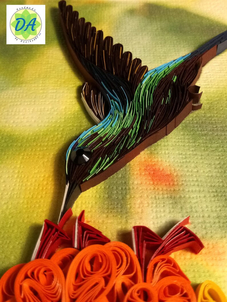 Thumbnail: Framed art of a hummingbird feeding from a red flower