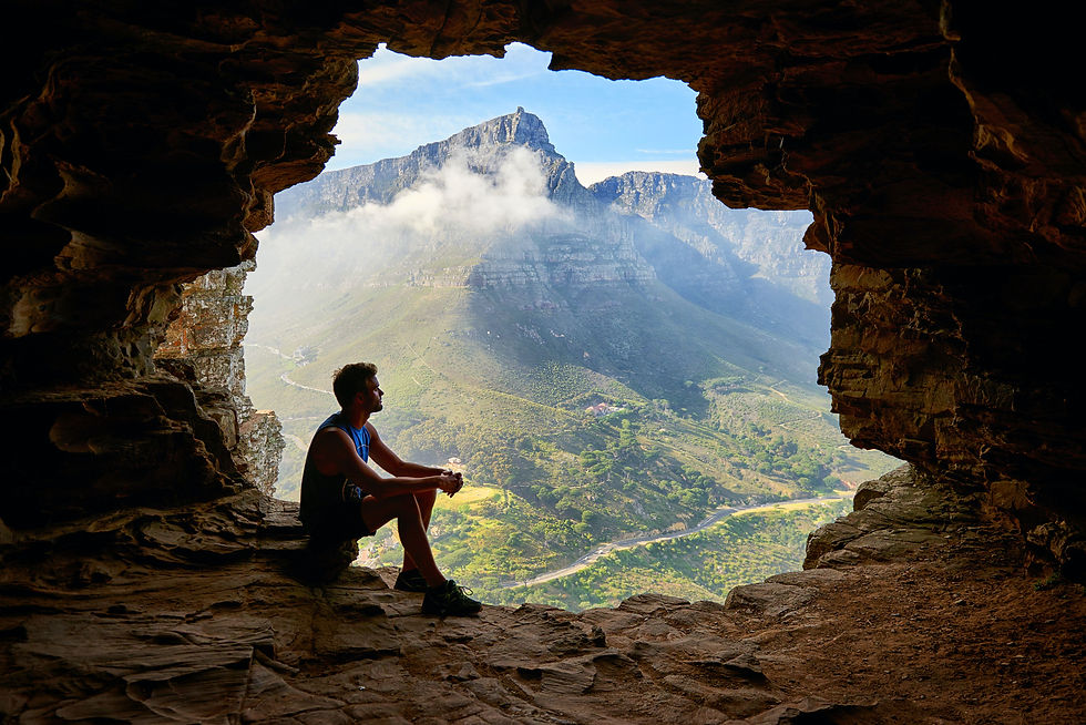 man in cave overlooking table mountain