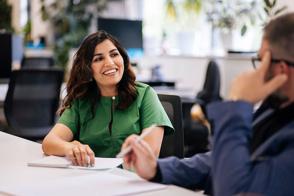 two colleagues smiling and discussing work