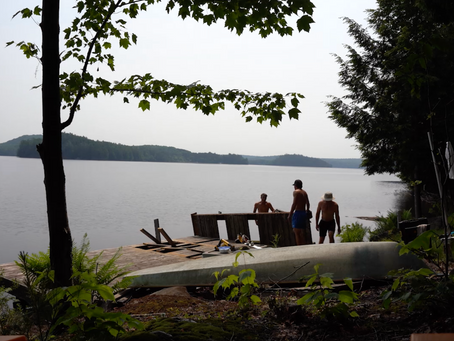 Boys on a dock that is being taken a part in pieces