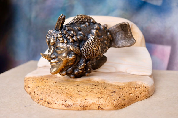 A bronze gourd fish sculpture on a wooden base