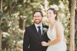 a bride and groom are posing for a picture and smiling