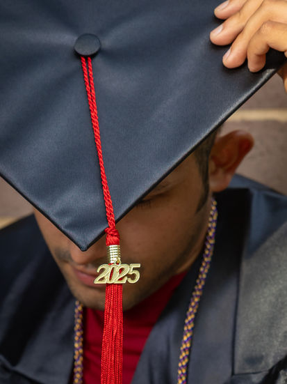a man wearing a graduation cap with a tassel that says 2025