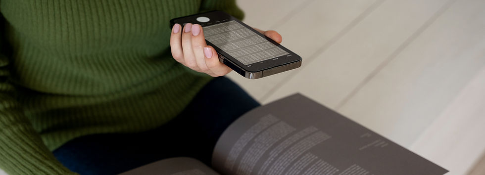 Hand holding a mobile phone with spreadsheets displayed on the mobile phone screen
