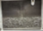 Close-up view of ice machine condenser coils being cleaned