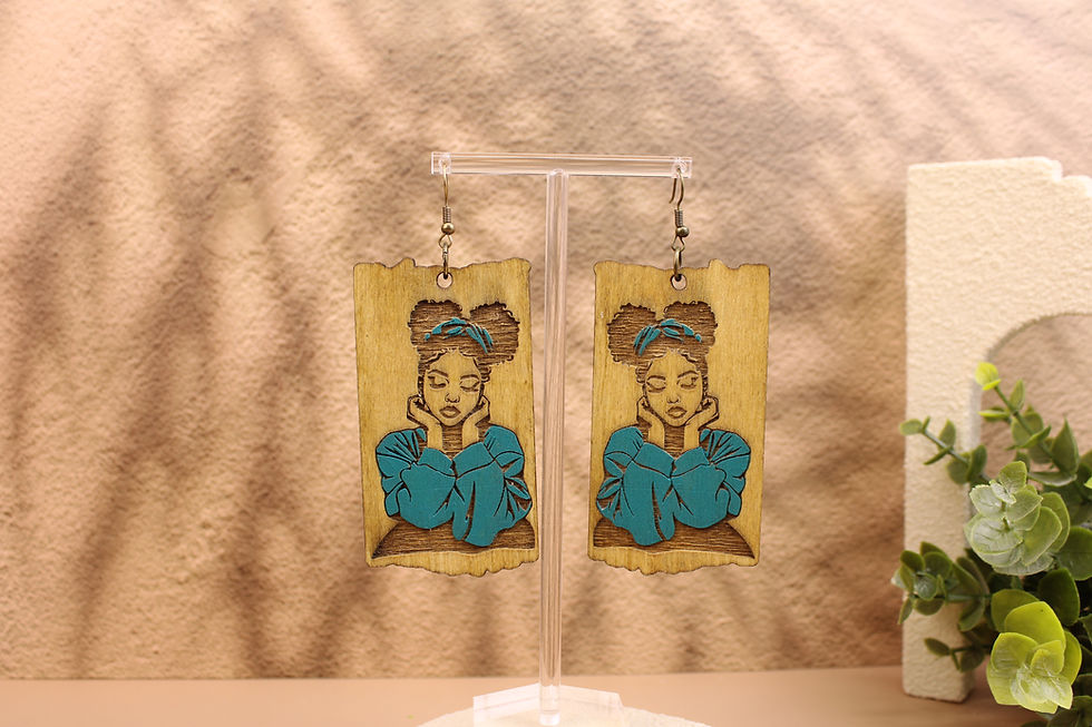 Double Afro Puff Beauty earrings on a display stand