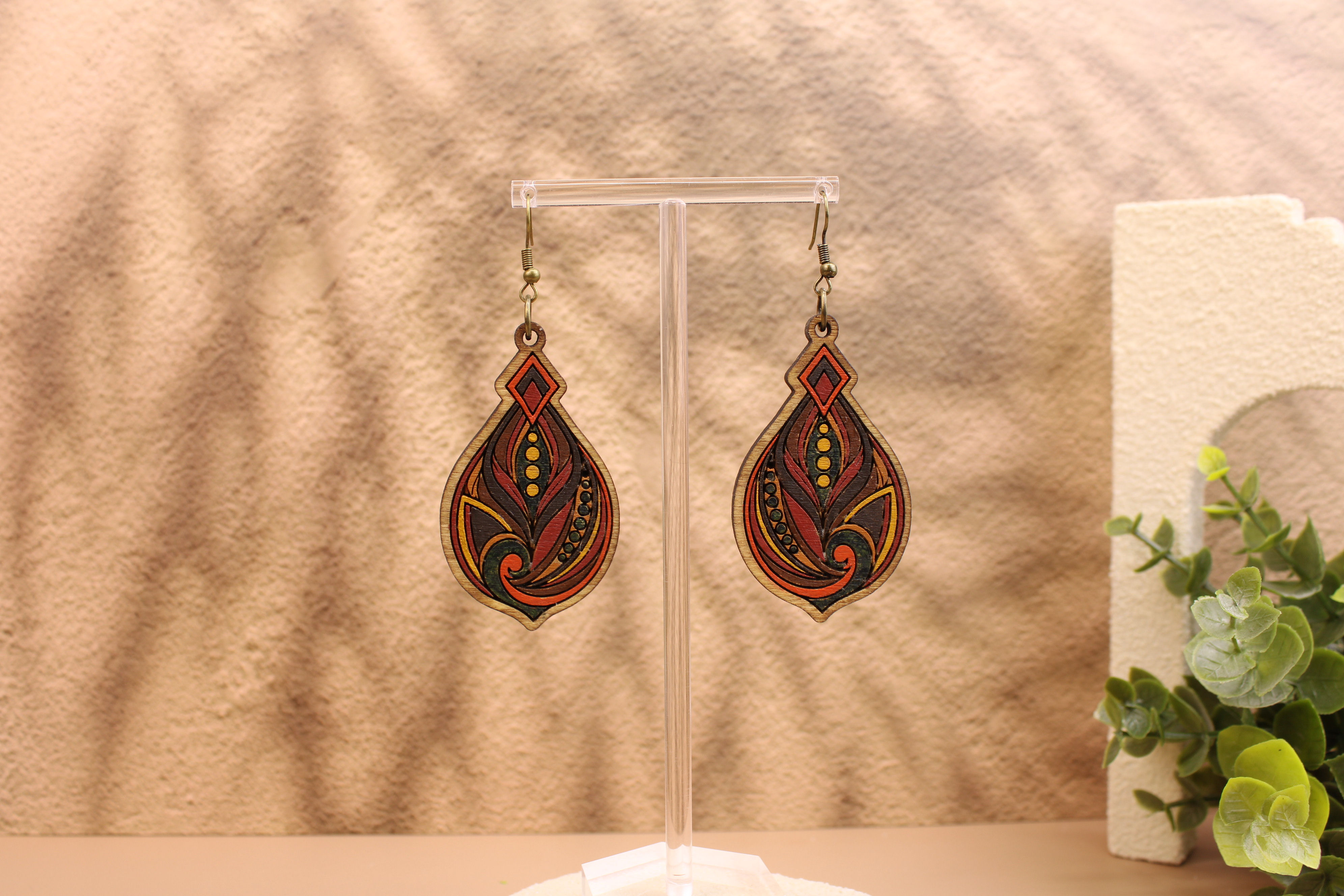 Ornate teardrop earrings with red and gold GTC448 patterns.
