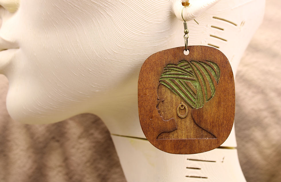 Wooden earring with carved profile of woman in headwrap