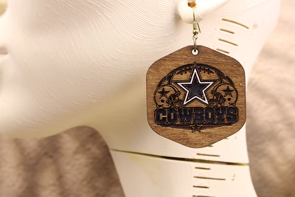 Wooden Dallas Cowboys star logo earring on a display bust.