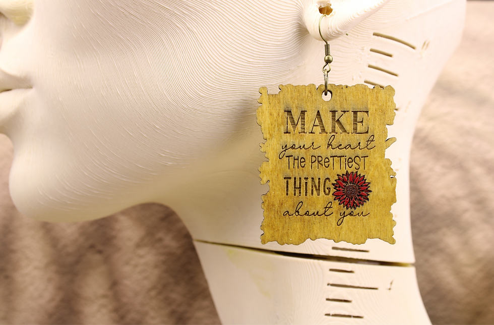Make your heart the prettiest thing earring on a mannequin.