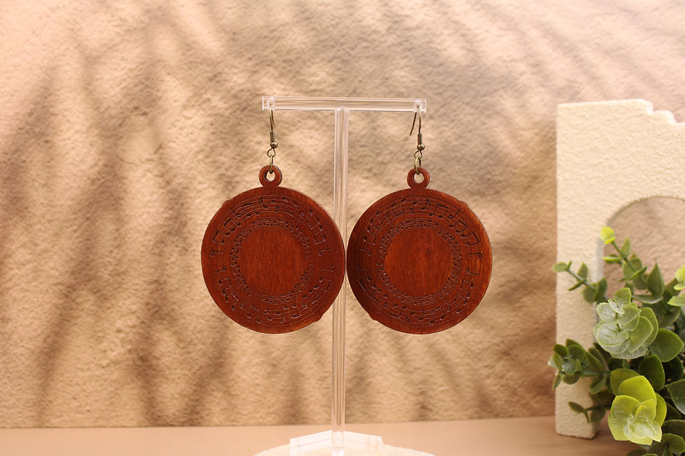 Rhythm & Roots round wooden earrings on a display stand.