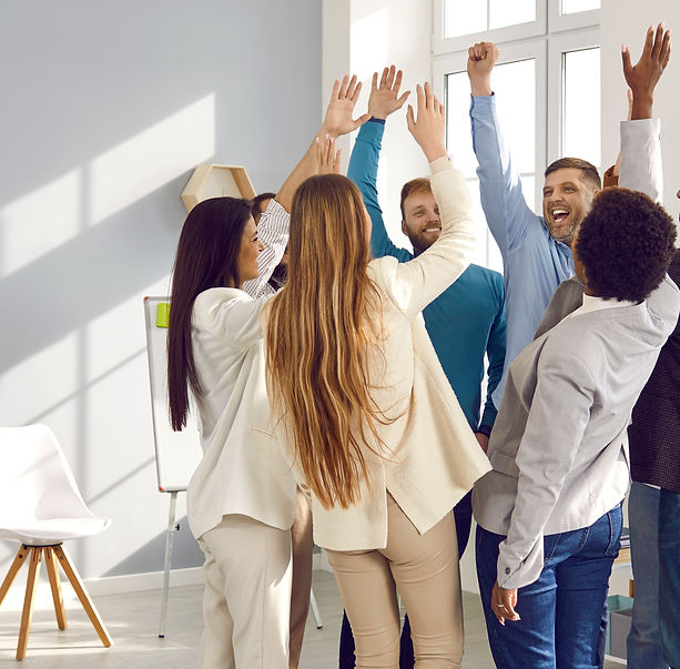 Happy participants stand in circle raise their hands up with smile during team building activity