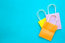 paper-bags-different-colors-blue-background-top-view.jpg