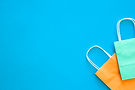paper-bags-different-colors-blue-background-top-view (1).jpg