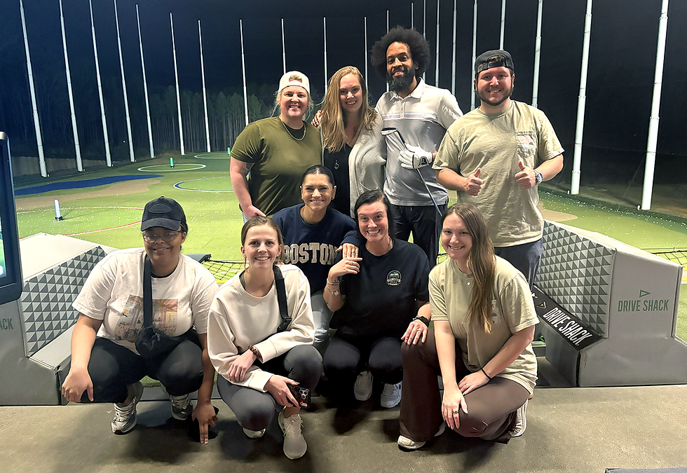 team outing at an indoor golf simulator