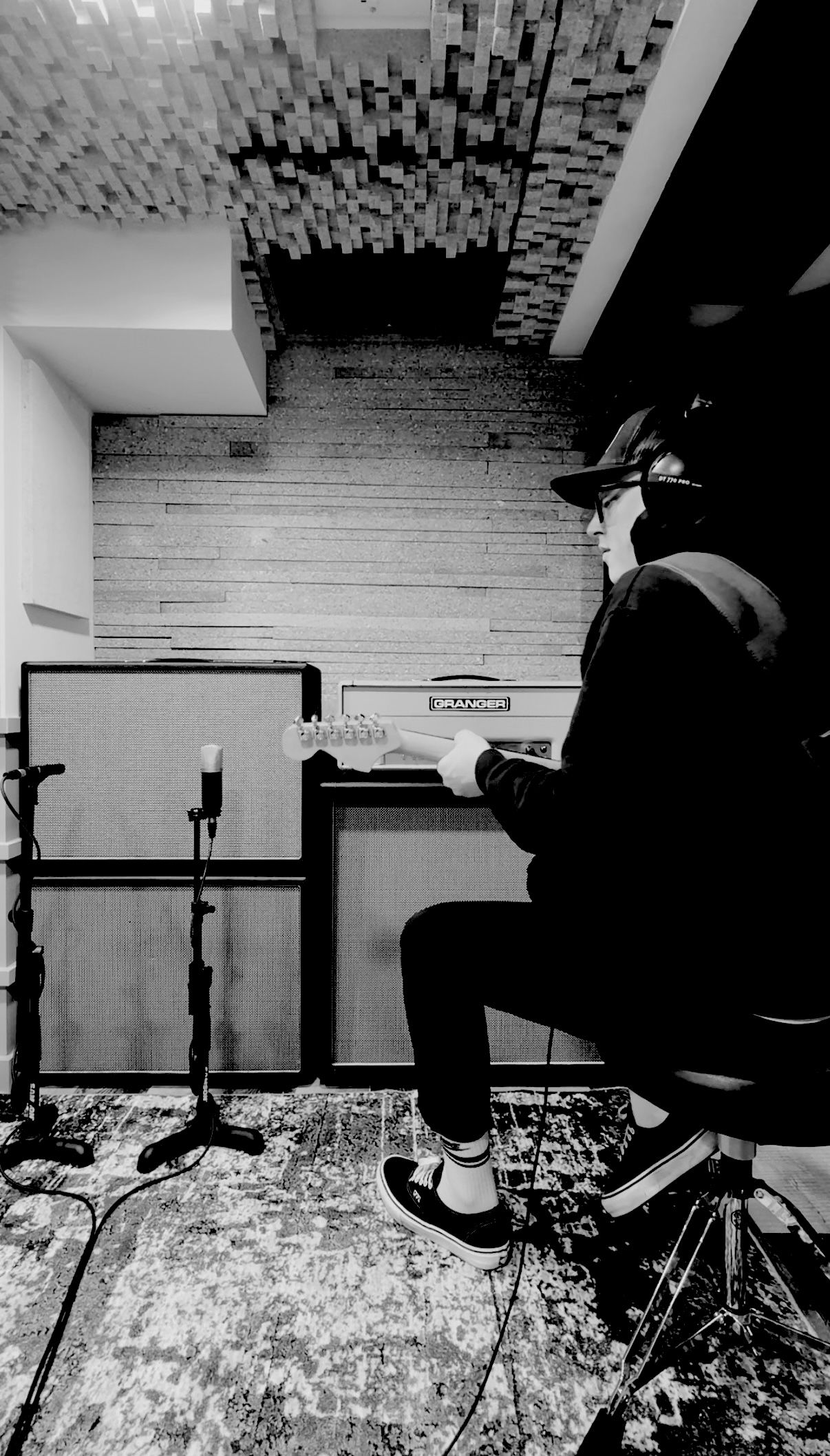 Custom Session Tracking cover image; founder is seated playing guitar with a wall of amps and speakers behind him.