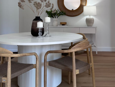 Modern dining room styled by Fresh Staging and Styling with natural timber chairs, white round table and contemporary decor