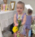 Young girl holding a flower bouquet in an event gallery