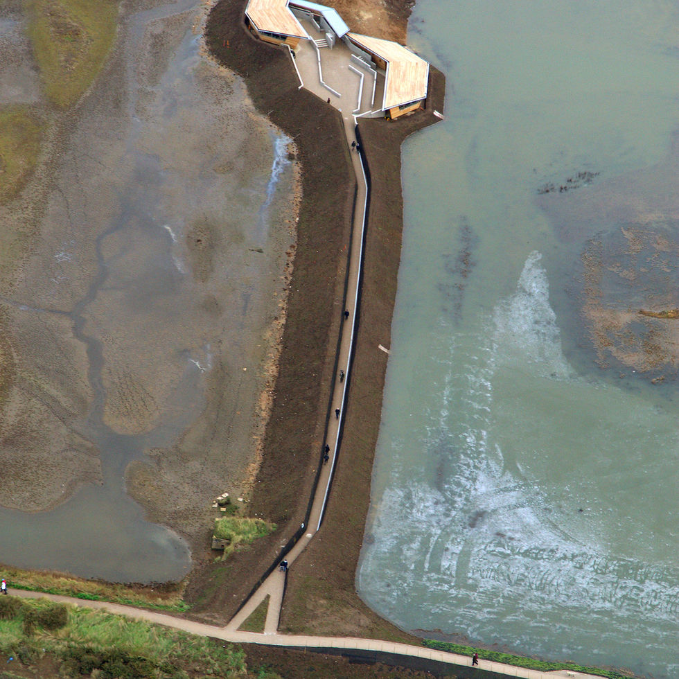 Aerial approach view of the RIBA Award-winning sustainable RSPB reception hide complex at Titchwell Marsh, Norfolk, designed by Haysom Ward Miller Architects for accessible birdwatching architecture.