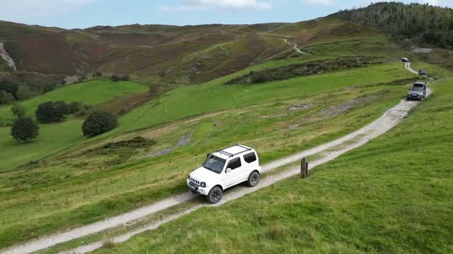White 4x4 on a remote hillside green lane in the Cambrian Mountains, Mid Wales