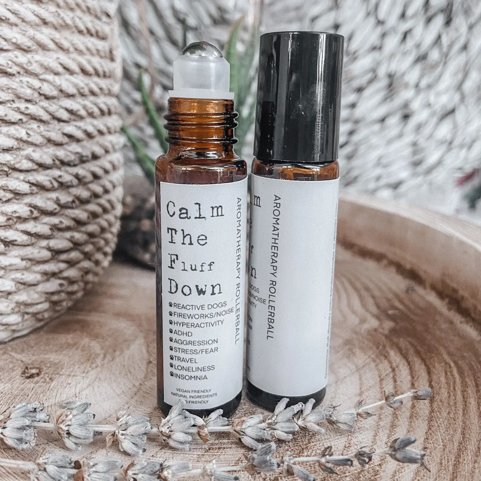 Two brown canisters roller ball calm the fluff down