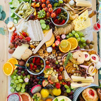 Luxury grazing table for weddings featuring gourmet cheeses, fresh fruits, crackers, and artisanal treats arranged elegantly for special events.