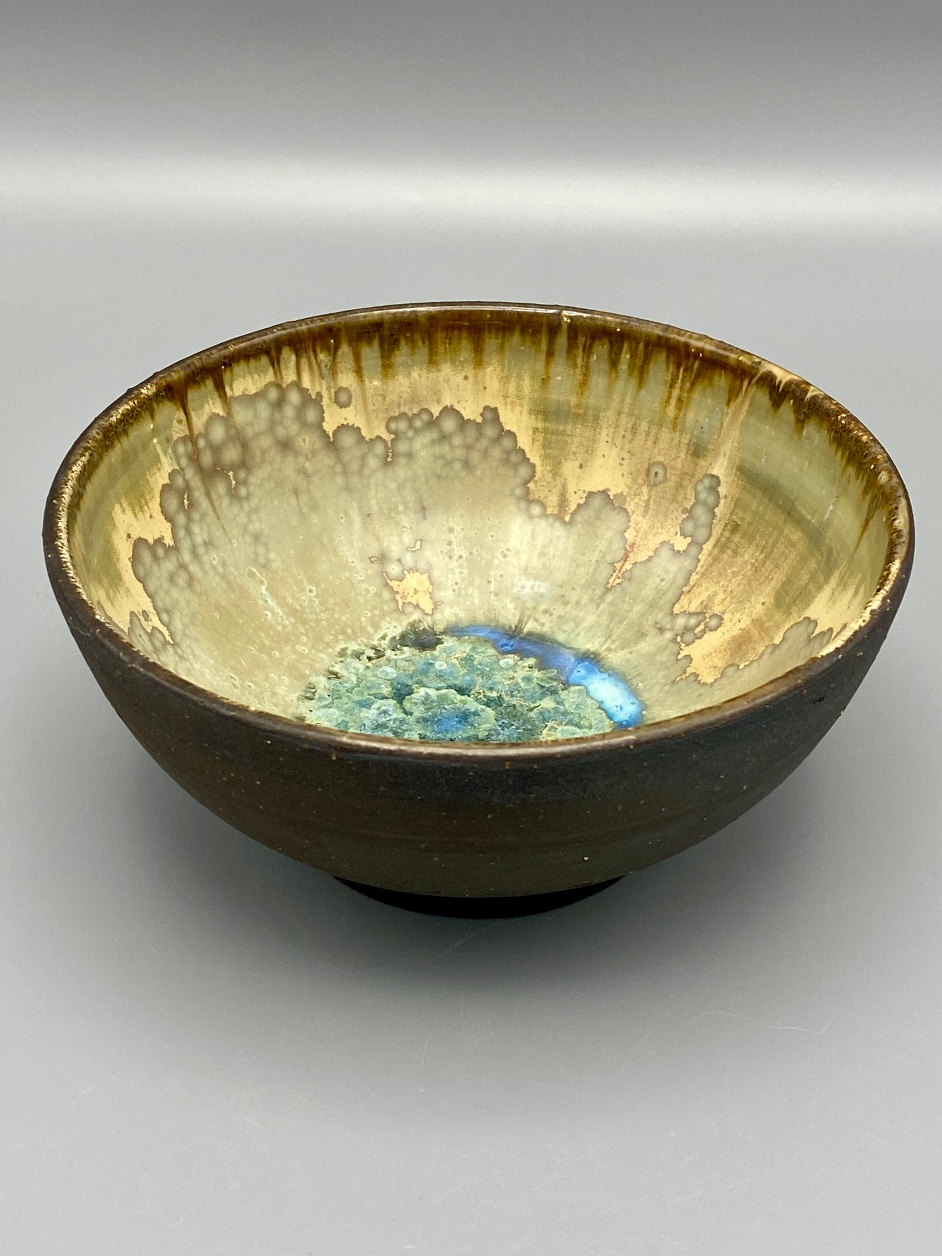 Back to Black bowl, turquoise crystals on a cream background