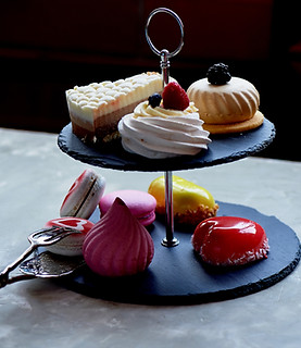 a small dessert tower full of meringue and petit gateaux.