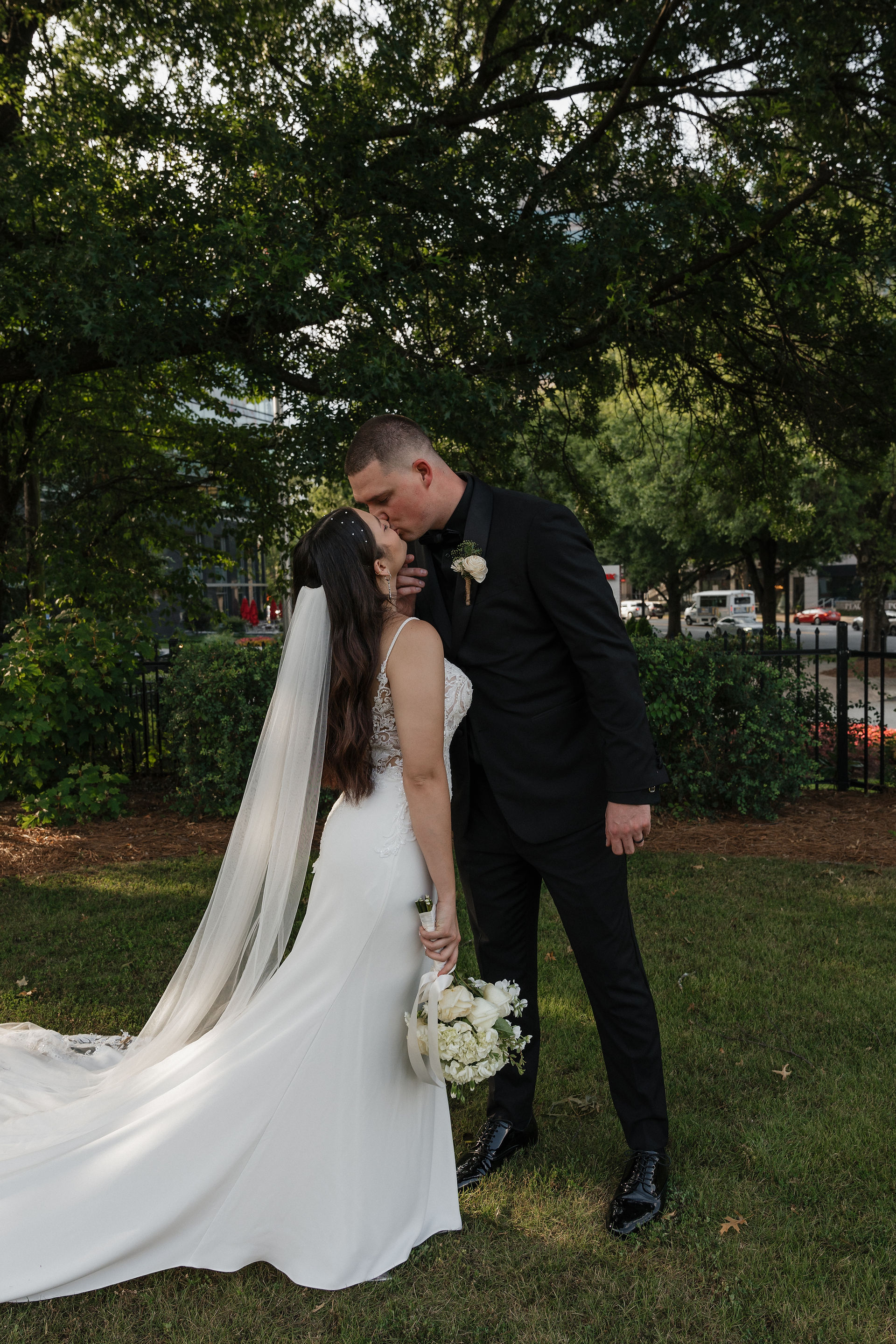 a kiss between a bride and groom