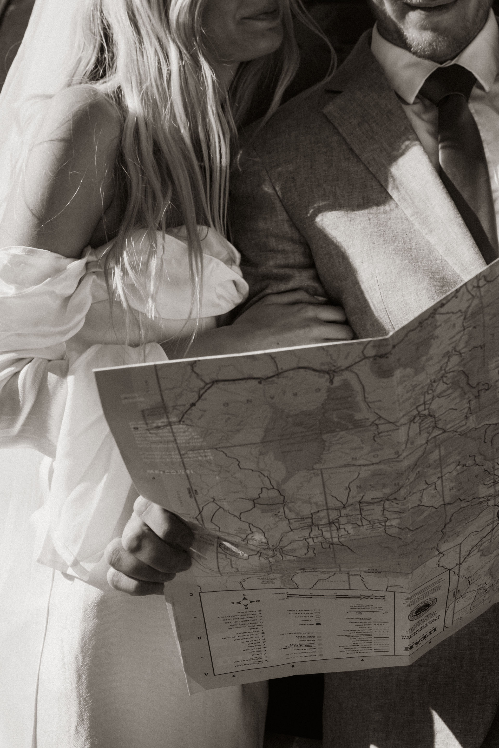 couple on an adventure reading a map in a national park