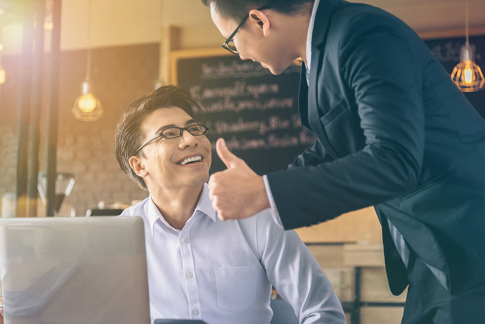 businessman-showing-thumbs-up-sign-young-colleague-office.jpg