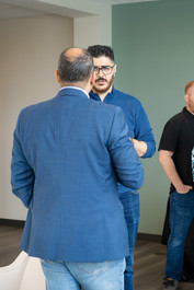 two men conversing at a networking event.