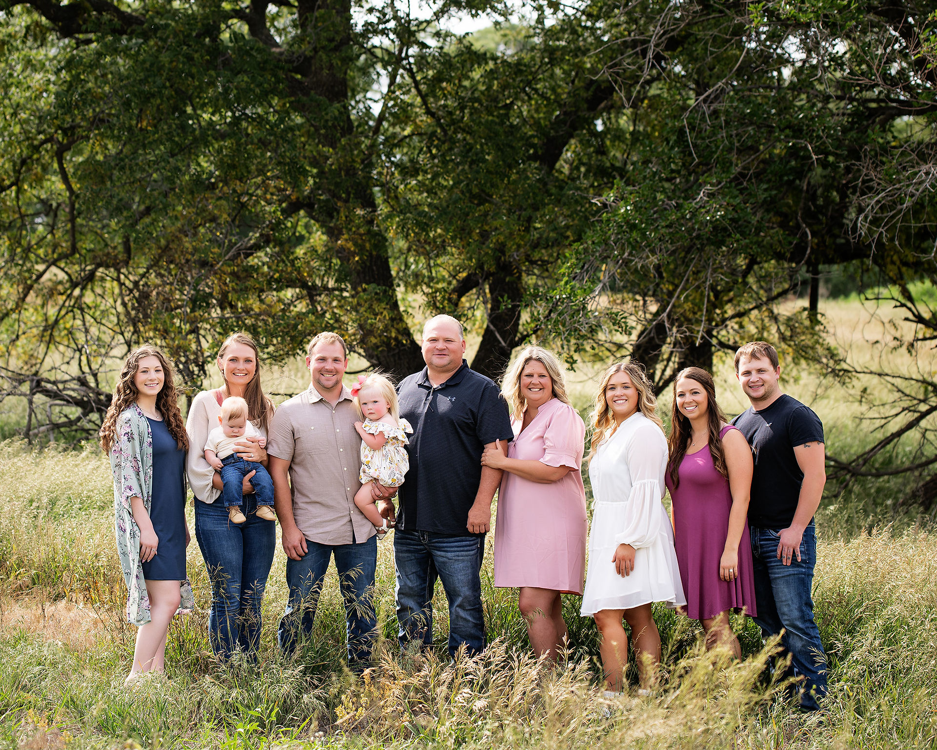 Family members standing side by side for an extended family event.