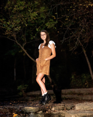 Senior girl standing at Stone Creek Falls after dark.